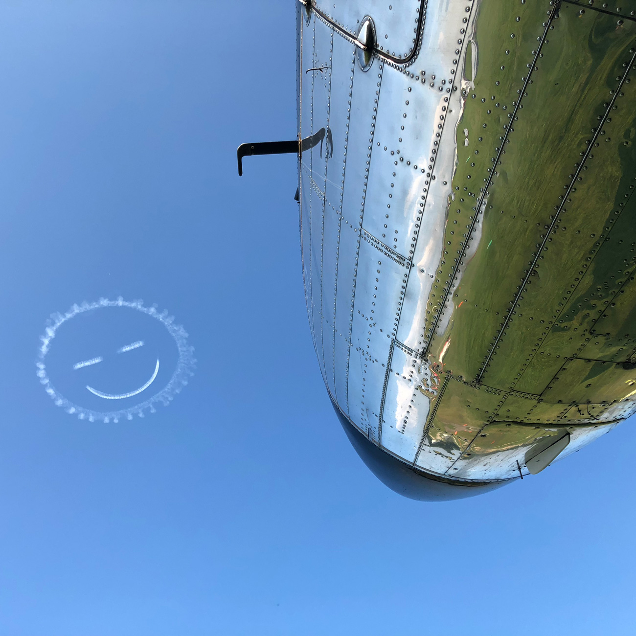 view of the noses of a long row of vintage airplanes
