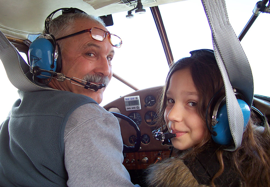 view of the noses of a long row of vintage airplanes